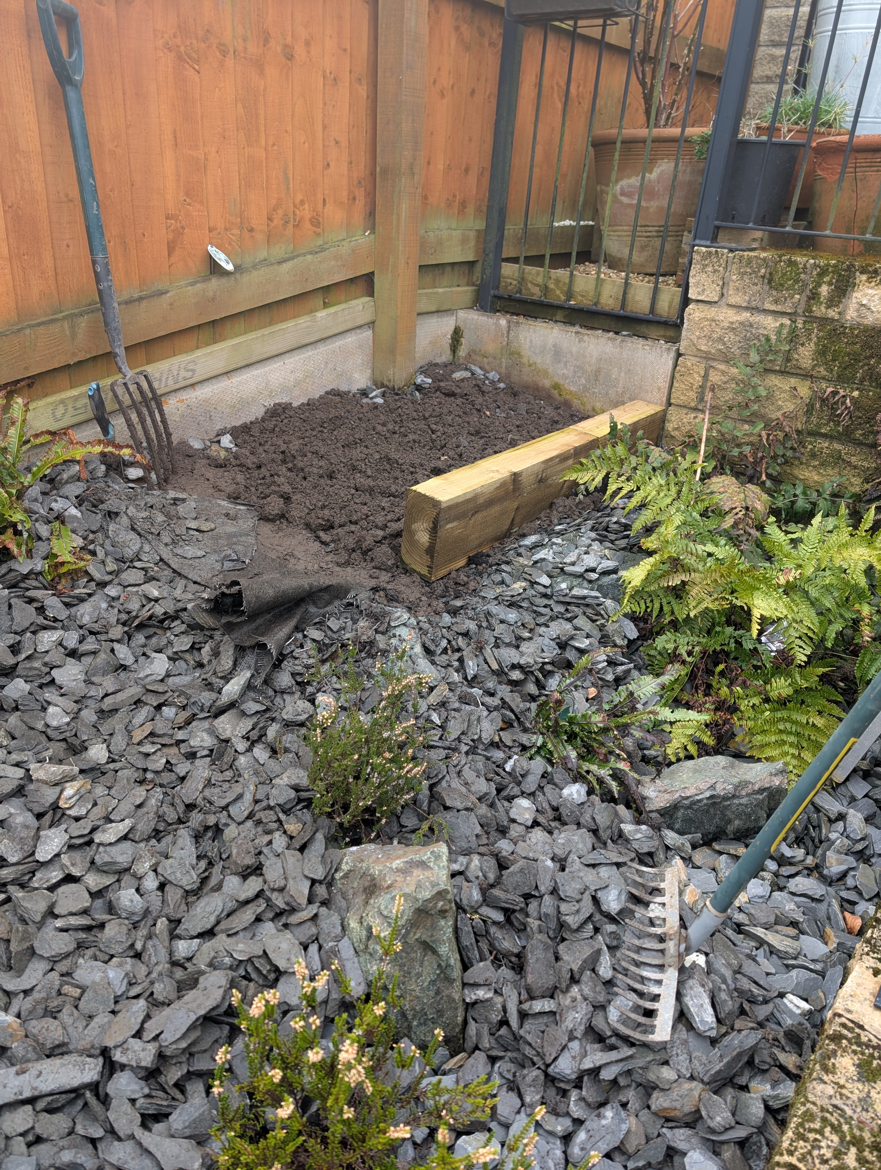 Part of my garden, it has been turned over, so that it is just bare earth. it is surrounded by slate chippings
